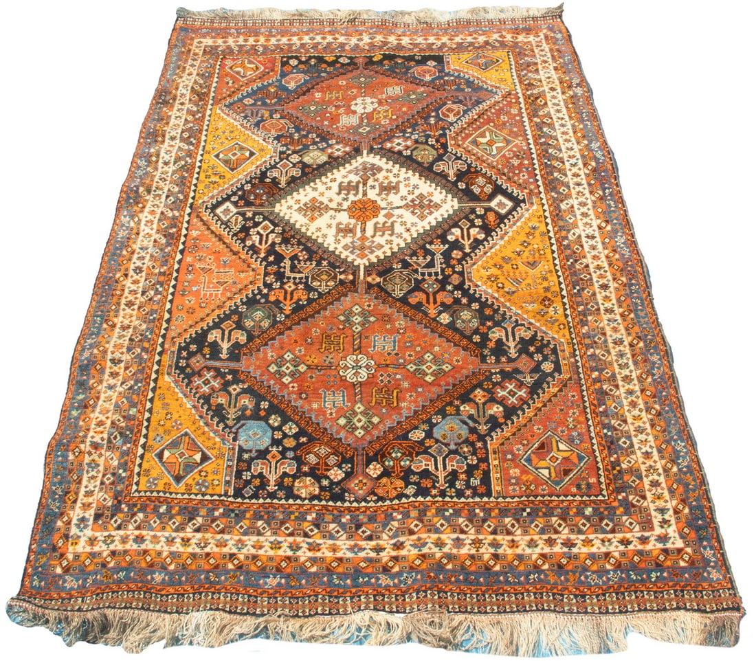 QASHQAI RUG (5'3"x7'10"): Southwest Persia, mid-20th Century. Three hooked diamond medallions in mahogany and ivory, flanked by bird motifs, diamonds, and botehs, in sky and Persian blue, goldenrod, ivory, and blue/green, on a