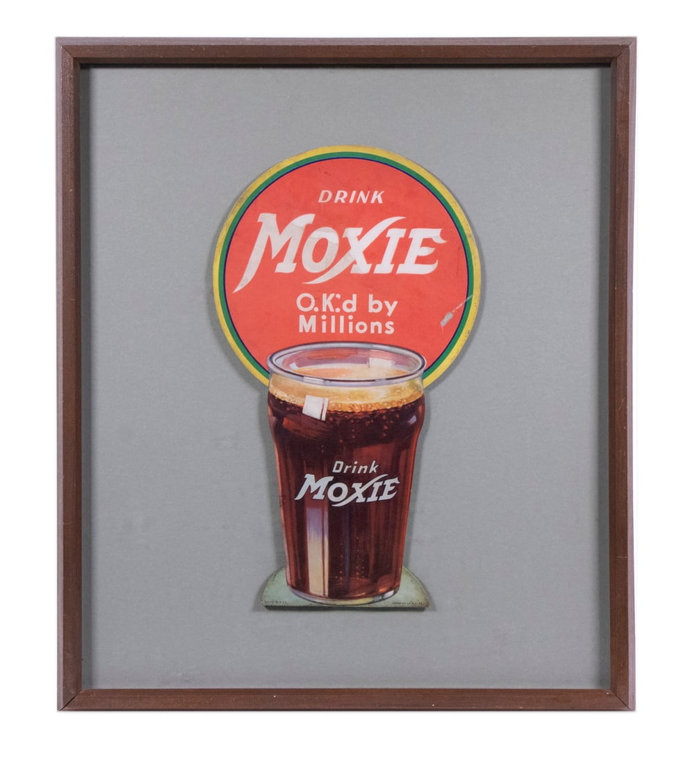 MOXIE DIECUT AD SODA GLASS, 1933, FRAMED: Easel back countertop ad, chromolitho on cardboard, "Drink Moxie, OK'd by Millions" on a yellow and green bordered red disc, numbered Form #LF, #2-33", with a full pint glass having the "Drink Moxie" 