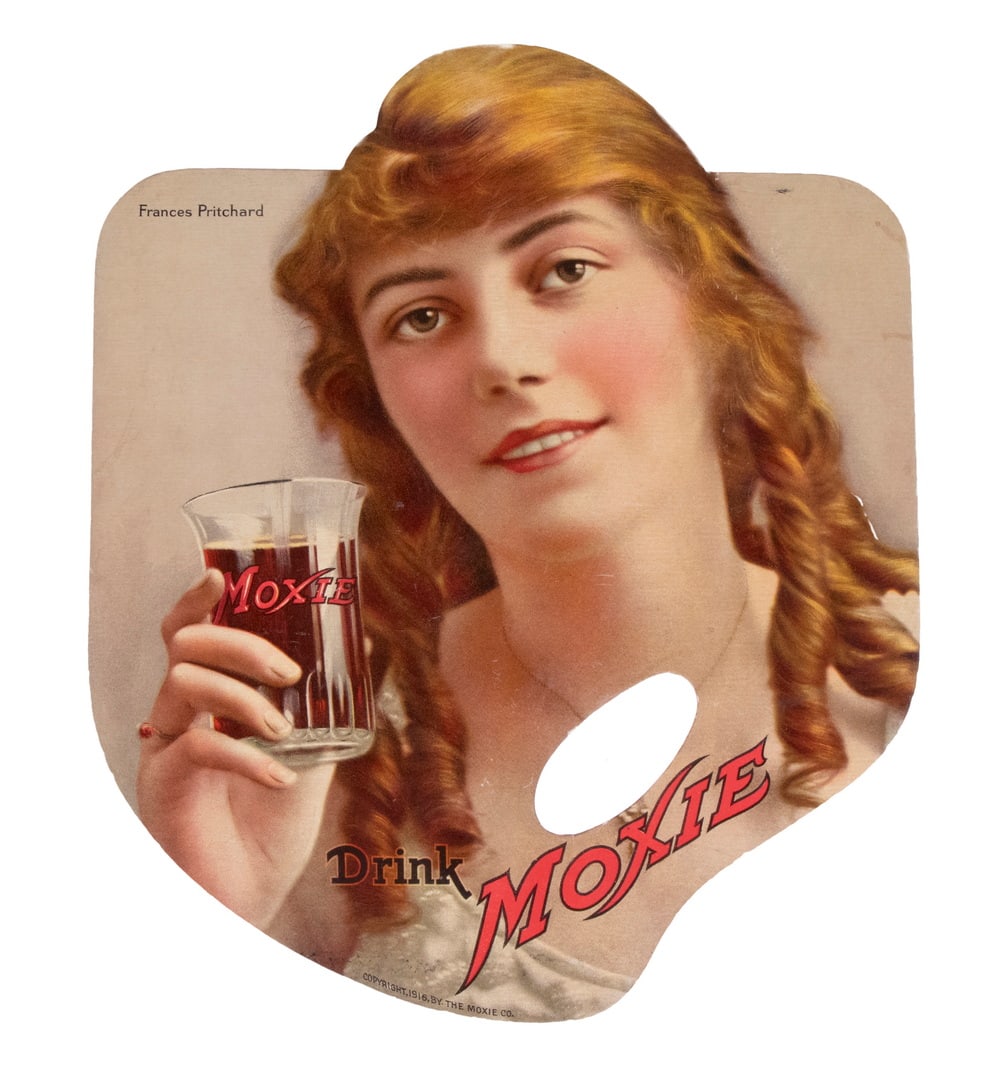 MOXIE HANDFAN, 1916, NYC DANCER FRANCES PRITCHARD: Diecut Chromolitho of the famous dancer in ginger ringlets holding up a Moxie glass, with the 'Drink Moxie' logo, marked with 1916 copyright. The reverse has a line drawing of a country fair with the