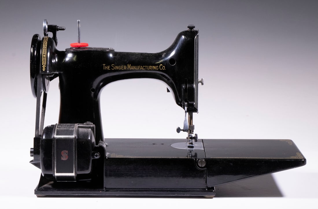 SINGER FEATHERWEIGHT SEWING MACHINE 221-1: Vintage Cased Portable Sewing Machine, model 221-1, sn AK586825, manufactured in 1951, with foot control and power cord, original instruction book, original case, case: 11" high, 14 1/2" x 8 1/2".