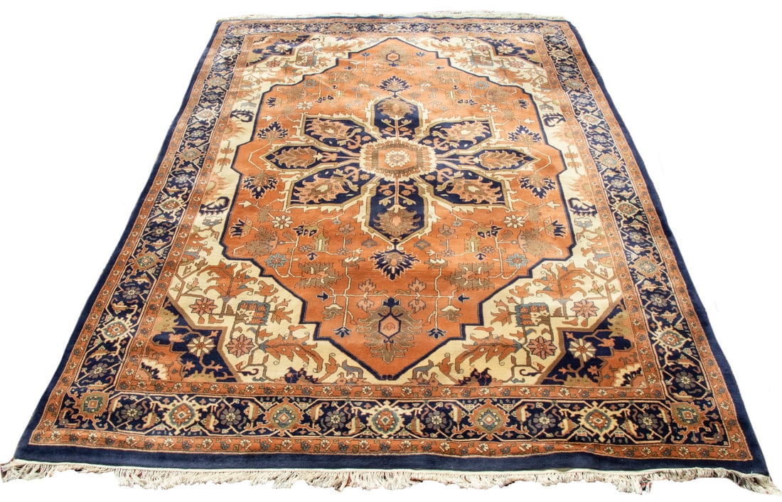 INDO-HERIZ CARPET 9'9"x13'6": India. Large serrated rosette medallion in midnight blue, sky blue, tan, and light rust. Surrounded by flowering vines and palmettes on a rust field. Midnight blue and ivory spandrels, with a midnight