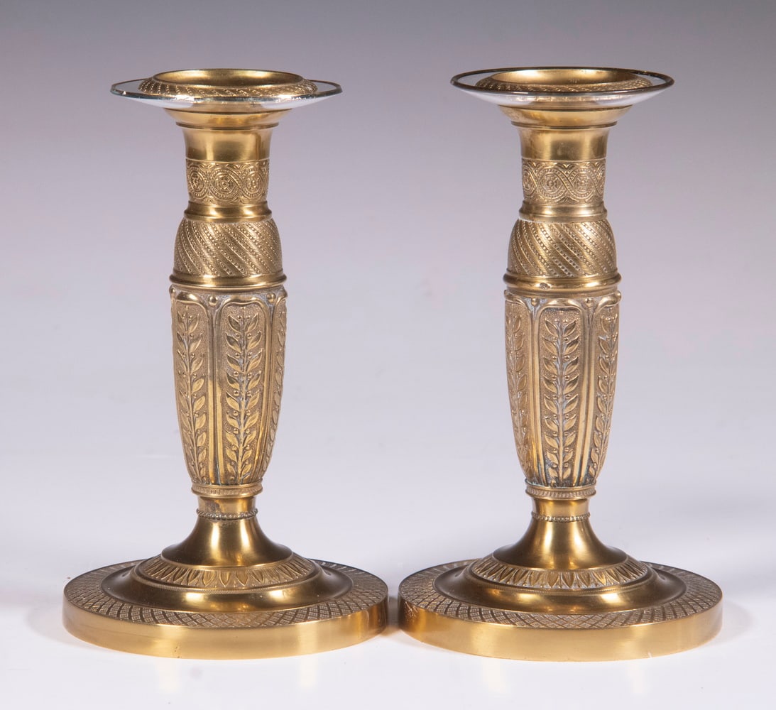 PR FRENCH EMPIRE CANDLESTICKS: Pair of 19th c. Gilt Bronze Candleholders, decorated with foliage and geometric motifs, set on round domed bases, w/both glass and brass bobeches, painted black shades, holders are 6 1/2" high, 4" dia