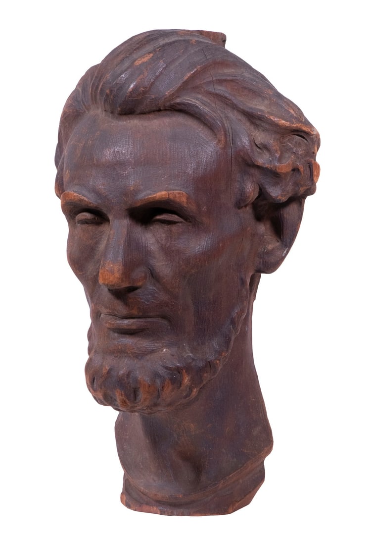 WOODEN WALL-HANGING BUST OF LINCOLN: Hand Carved Red Walnut Bust with flat back, circa 1875, probably a Centennial piece, very animate, unsigned. 16" tall.