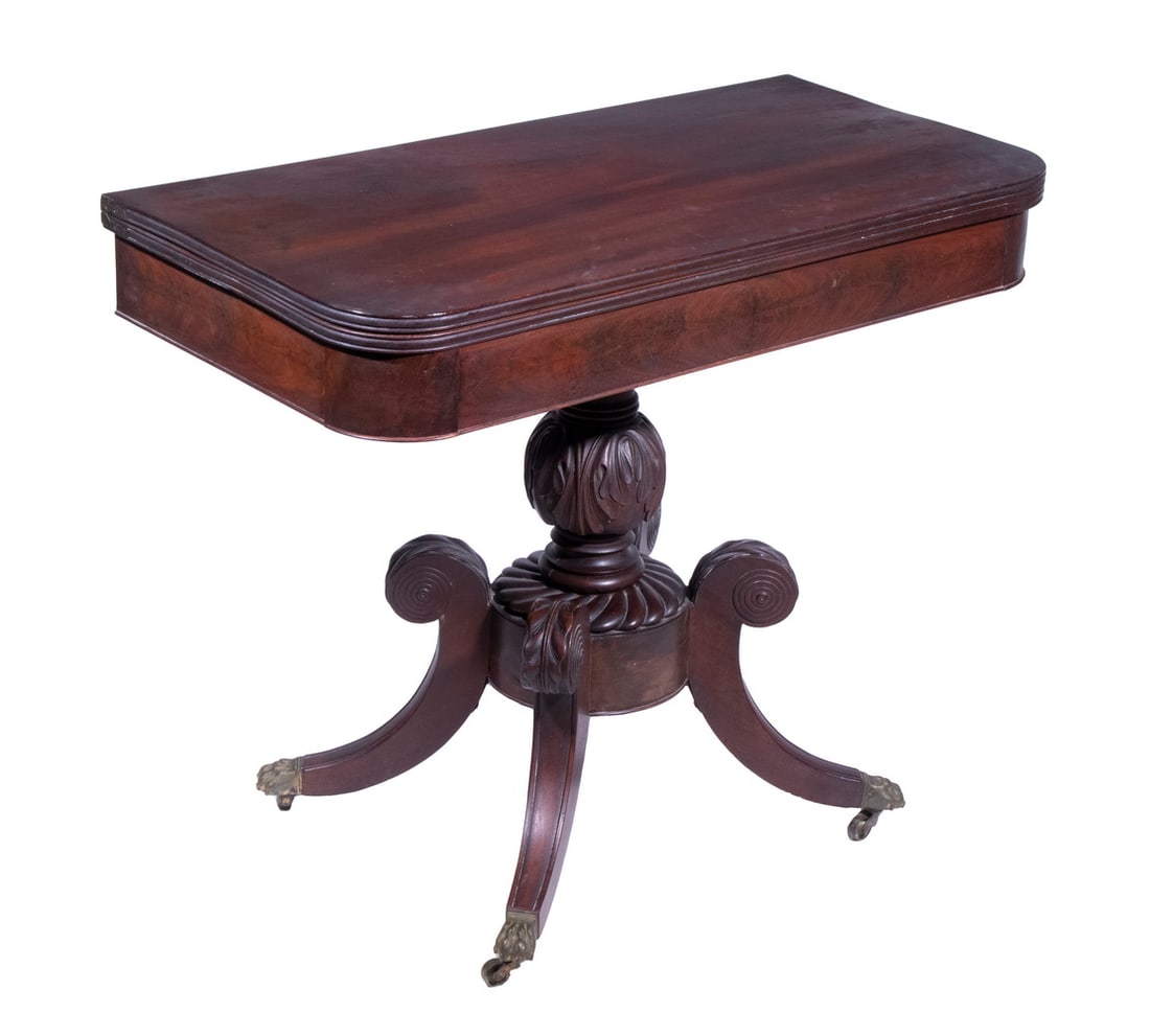 FEDERAL DUNCAN PHYFE FORM CARD TABLE: 19th c. Mahogany Pedestal Base Card Table, with pivoting folding top and interior storage, atop an ornately carved pedestal base, set on curved legs with brass capped paw feet with casters, 30" high,