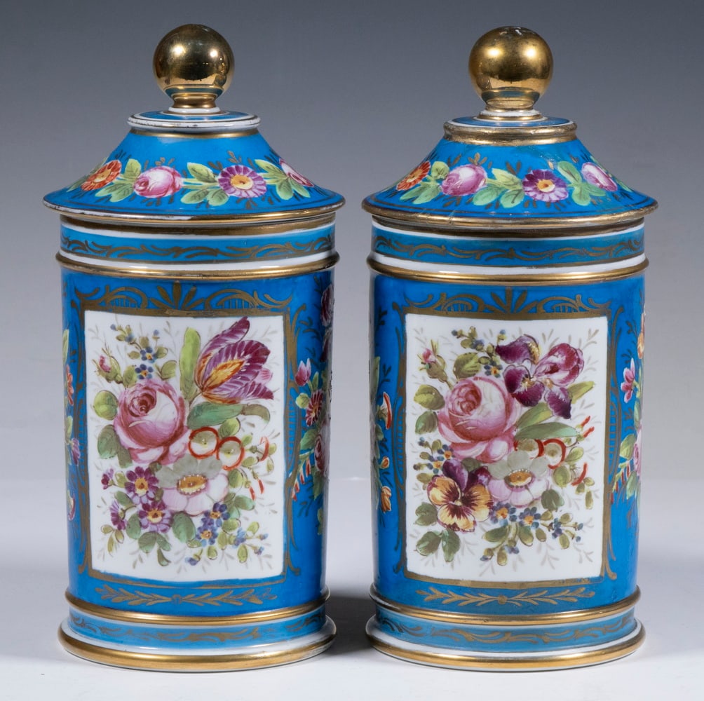 PR SEVRES STYLE HAND PAINTED PORCELAIN JARS: Pair of 19th c. Cylindrical Lidded Jars, with hand painted floral decoration on a medium blue ground, gilded trim, bases with painted blue interlaced Ls mark topped with "A" and centered with "VX", "S
