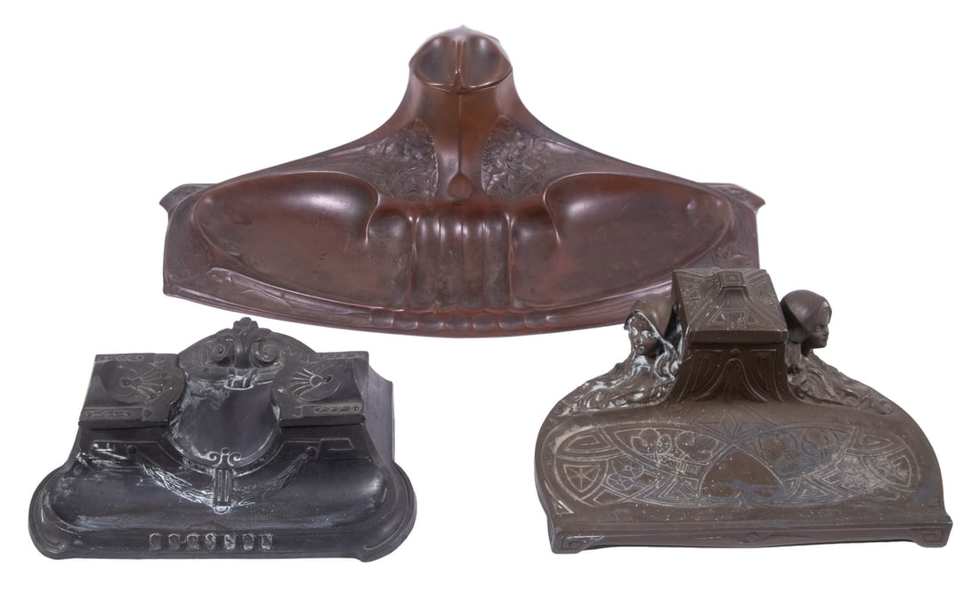 CONTINENTAL ART NOUVEAU INKSTANDS: Lot of (3), early 20th c., incl: Patinated metal stand, flowing form with relief molded grapevine decoration, with pen holder, hinged lid inkwell with glass liner, 4" high, 14 1/2" x 8 1/2"; Patinated