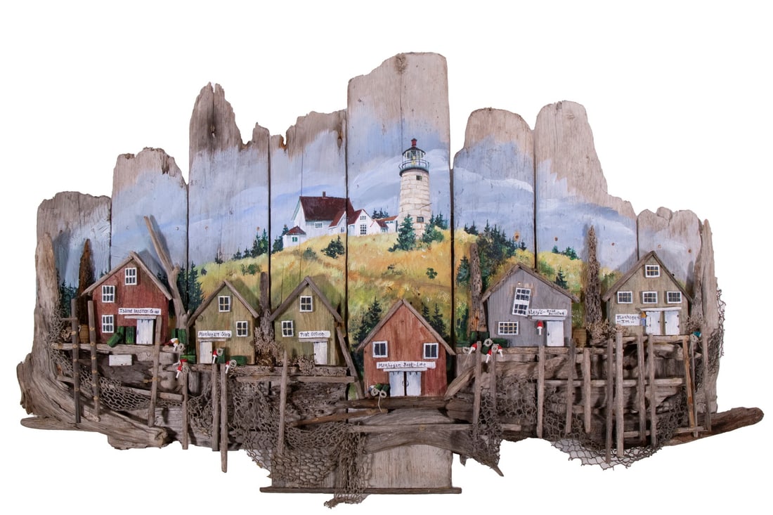 MAINE FOLK ART VINALHAVEN DIORAMA: Handcrafted Rustic Dock Scene, constructed of painted driftwood and netting, depicting a variety of Vinalhaven dockside businesses, with painted lighthouse background, unsigned, 21” high, 36R