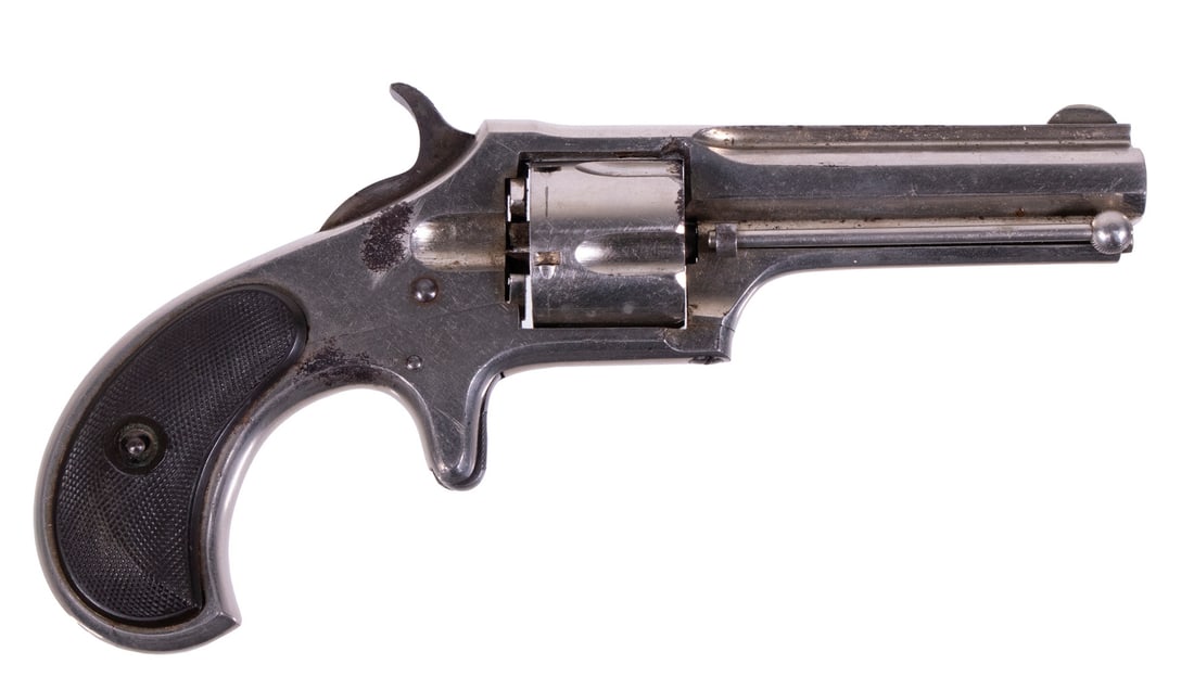 REMINGTON-SMOOT REVOLVER, .30 RF: A single-action pocket revolver made by the Remington Arms Company. The revolver features a nickel finish throughout with octagonal ribbed barrel, fluted cylinder, spur trigger, case ejector and check