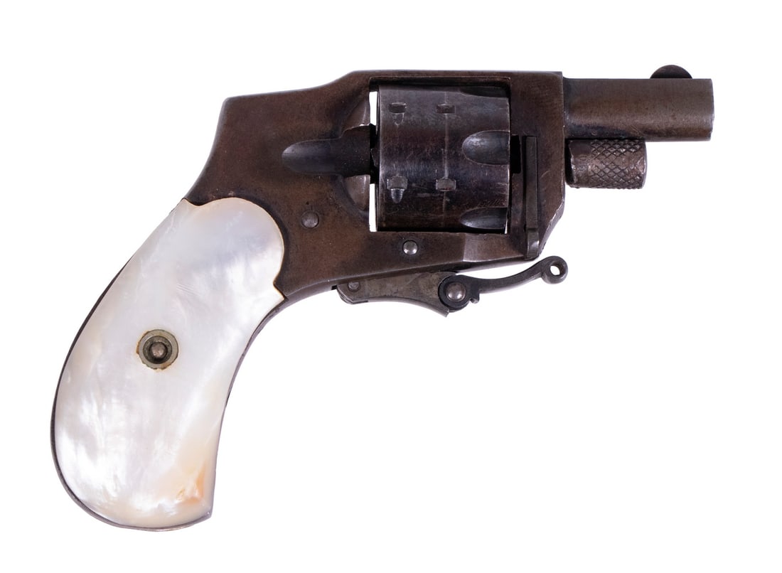 KOLB BABY HAMMERLESS POCKET REVOLVER, .22 SHORT: A miniature pocket revolver made by Kolb. The revolver features a blued finish with mother of pearl grip panels and folding trigger. The firearm is double-action only with a fully shrouded hammer. The
