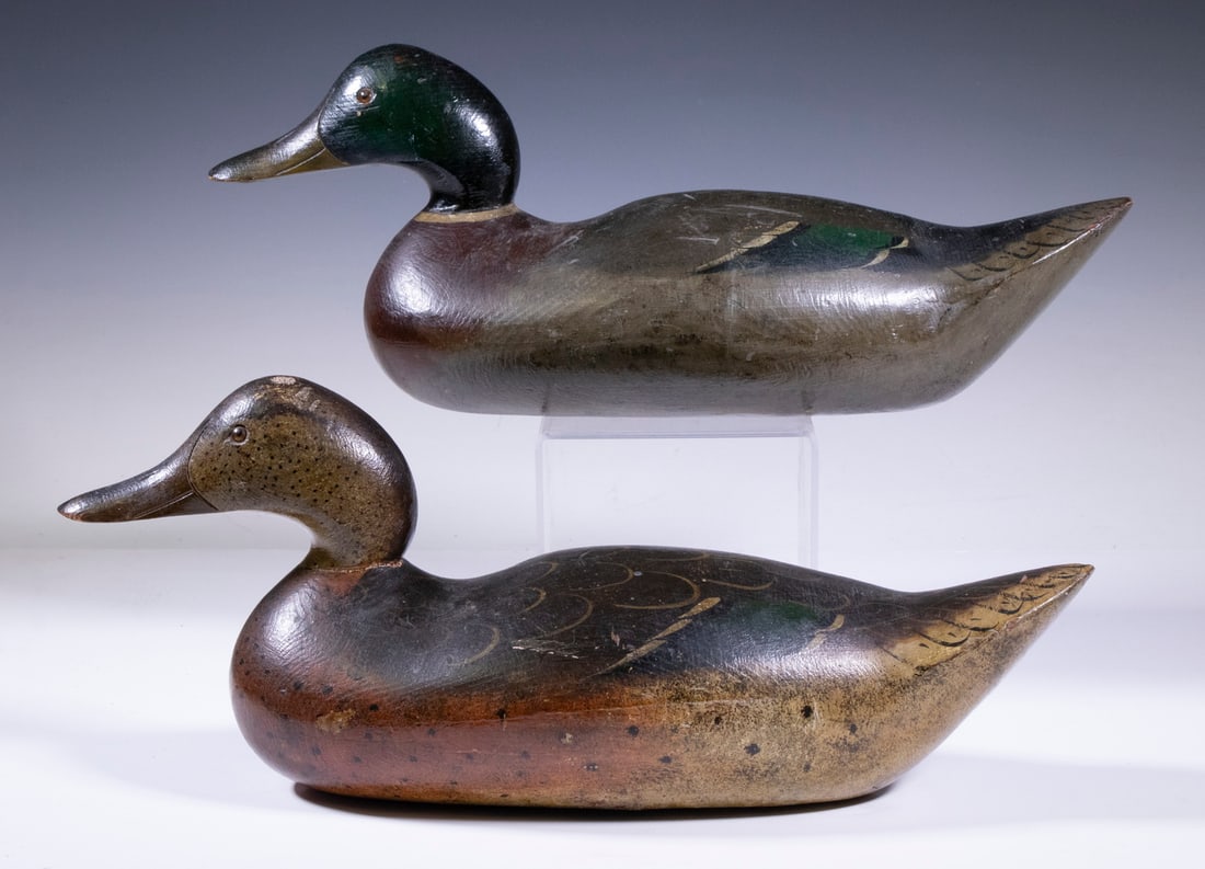 MASON CHALLANGE GRADE DECOYS: Pair of Vintage Carved and Painted Wooden Decoys, depicting a Mallard drake and hen, with glass eyes, unsigned, 7" high, 17" wide. Base shrinkage cracks; neck repair and tail chip to hen.