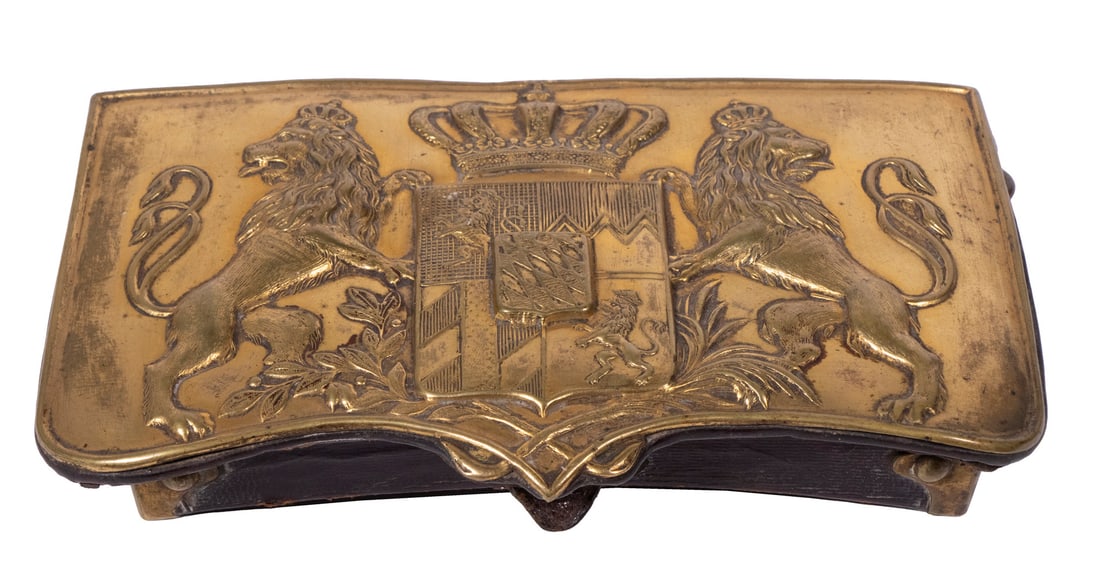 19TH C. BRITISH CARTRIDGE BOX: Oxblood Leather Belt Case with brass fittings and heraldic pressed brass flap cover, featuring rampant opposing lions flanking a crowned shield. 4" x 6 1/2" x 1 1/4".