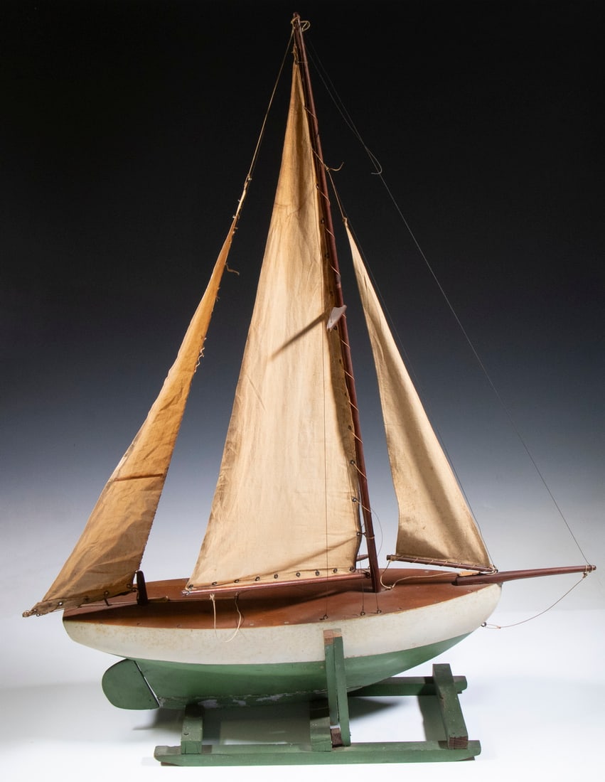 VINTAGE HANDMADE POND MODEL SAILBOAT: Circa 1920s Hand Crafted Model of a Sailing Yacht, with three sails, hollow hull and leaded keel, atop a handmade painted stand, 38" high (boat only: 36" high), 31" x 8 1/2".