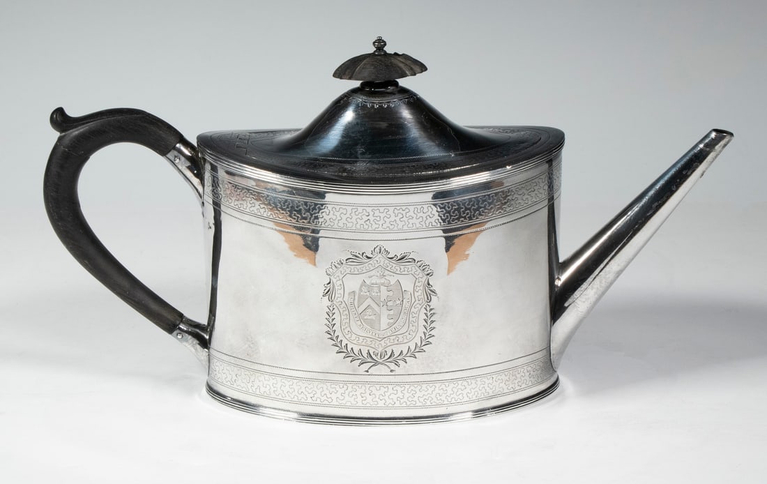 GEORGE III STERLING TEAPOT BY ROBERT HENNELL I: English Sterling Silver Oval Teapot, by Robert Hennell I, London, 1794, having a domed lid with ebony finial, ebony handle, tapered tubular spout, with engraved Vaughan family crest with motto "Christ