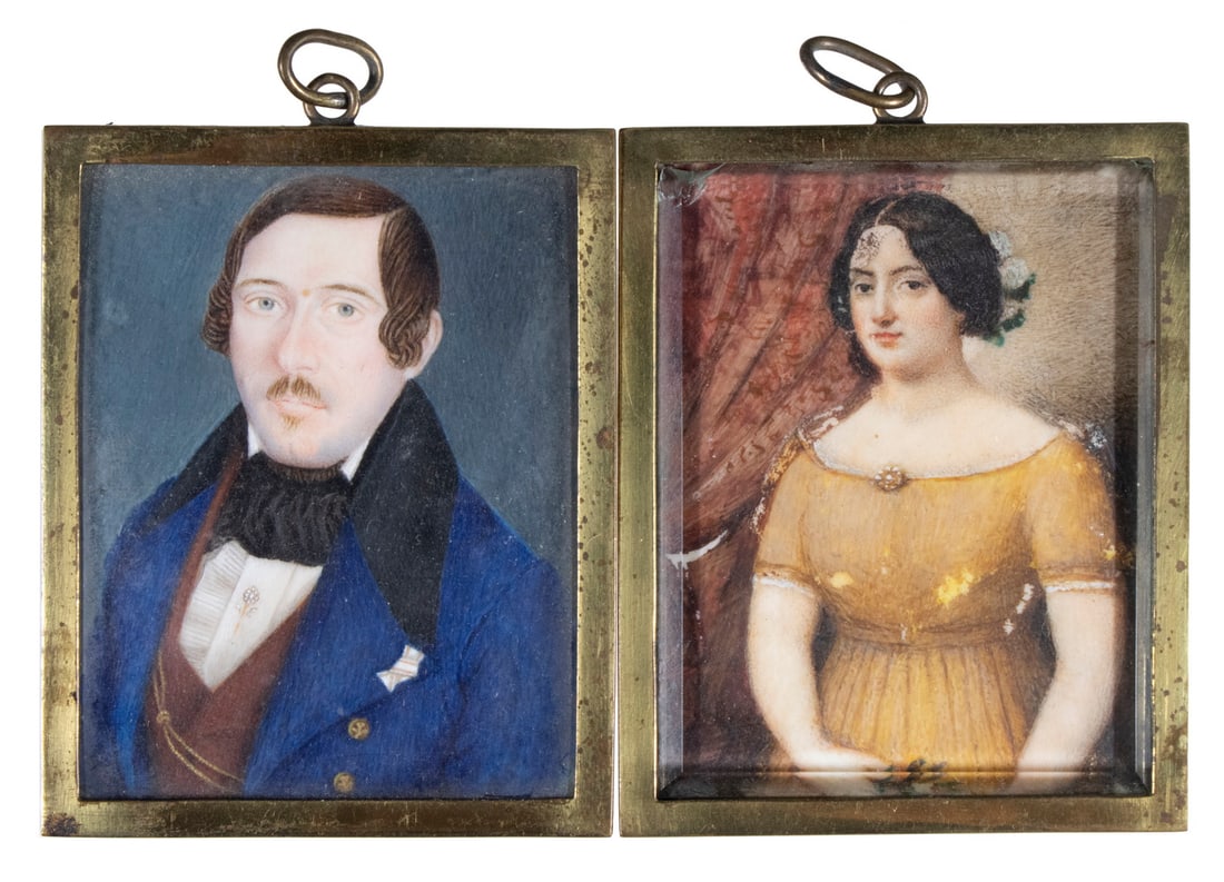 PAIR OF EARLY 19TH C SPANISH MINIATURE PORTRAITS: A Young Couple from Madrid, oil on ivory, circa 1820, the woman in an ochre empire waisted gown, holding a posy, in front of a wine drape; the man with blue eyes and a small moustache, is in a blue ja
