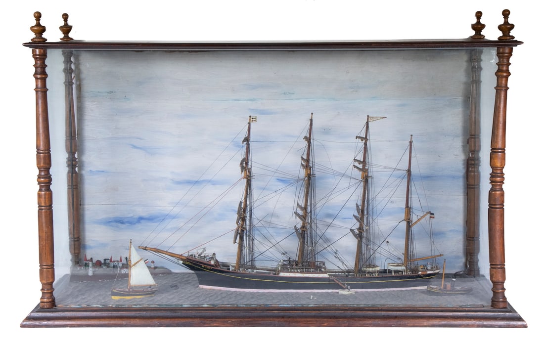DIORAMA OF A GERMAN BARK, CIRCA 1895: Ship Model of the "Placilla", from the "Flying-P Line" of Hamburg, in a three-sided glass case with sky painted backing, depicted moored with no sails up, several small craft and a fragment of a villa