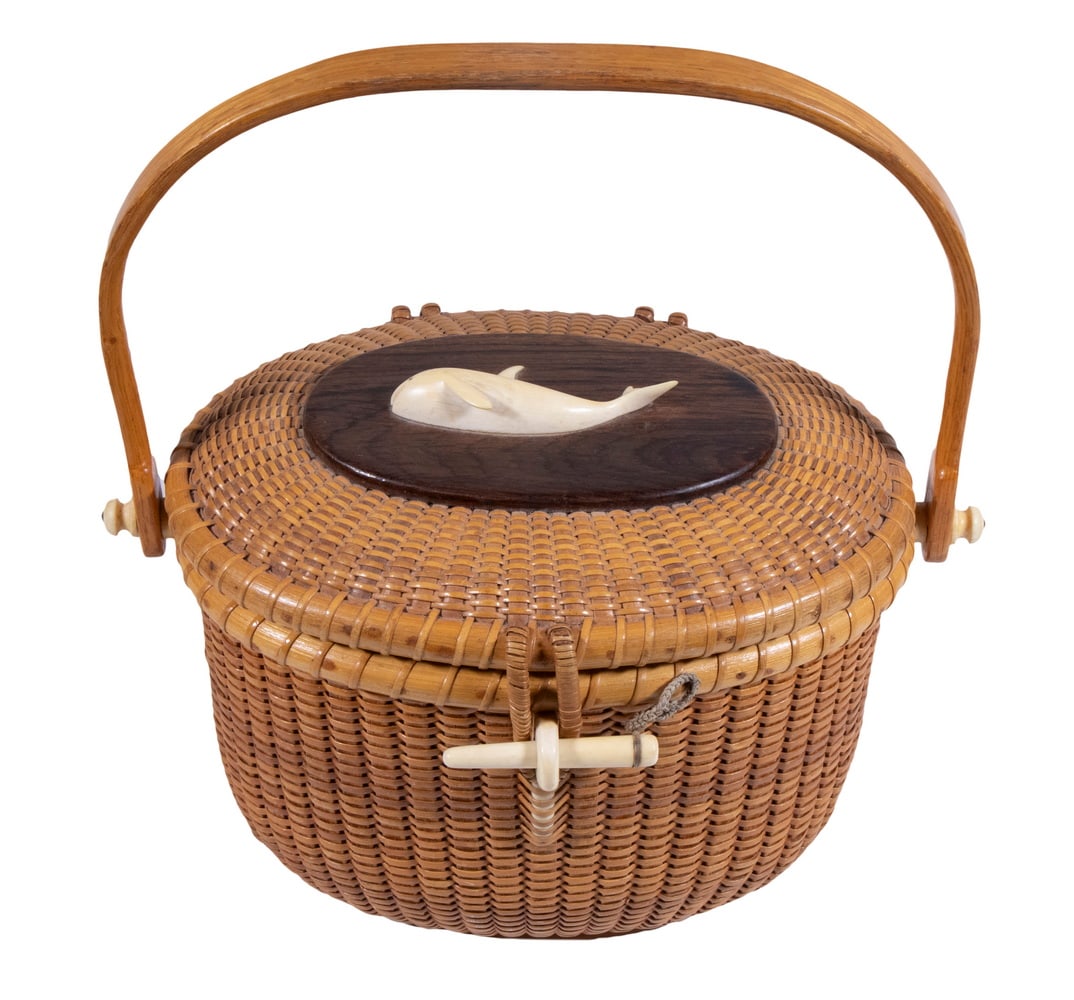 NANTUCKET BASKET PURSE BY STEPHEN GIBBS: Oval Swing Handle Friendship Basket, by Nantucket builder, woodworker and basket artisan Stephen Gibbs (1896-1974), the lid having an oval wooden panel with affixed carved bone whale, wide carved bone