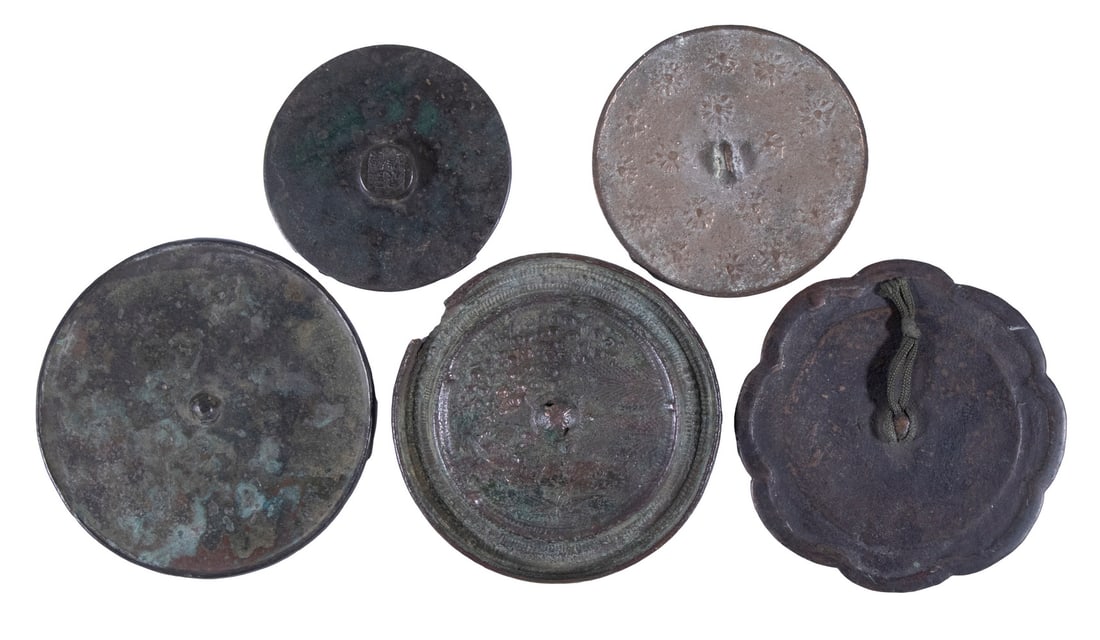 (5) EARLY CHINESE BRONZE HAND MIRRORS: Collection of Antique Mirrors, all with central loop, incl: Scalloped shape mirror, 4" diam.; Tang dynasty mirror with central cast inscription, 2 3/4" diam.; Unembellished mirror, 4" diam.; Mirror wi