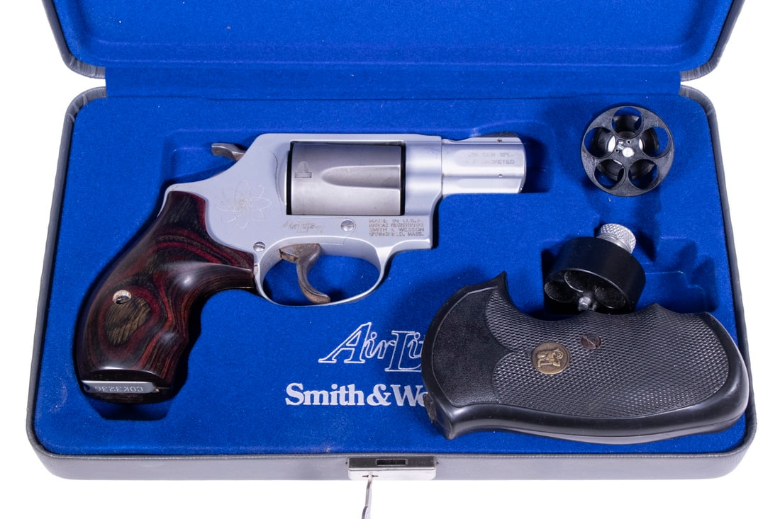 S&W AIR LITE TI SNUB-NOSE REVOLVER, .38 SPL +P: A lightweight, DA/SA snub-nose revolver manufactured by Smith & Wesson. The gun features a matte nickel finish throughout, a fixed front blade and trough rear sight, and laminated wood grip panels. In