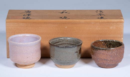 (3) 20TH C. JAPANESE RAKU GLAZED TEA CUPS IN SIGNED BOX: Chaku Rawan Small Tea Ceremony Cups in three dIfferent glazes on hand thrown terracotta, preserved in a partitioned kiri wood box with inscription and seals, printed paper in Japanese, 2 1/2" diam. cu