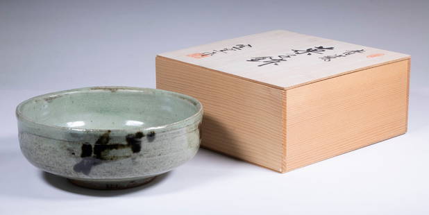 JAPANESE CELADON RAKU BOWL IN SIGNED BOX: Celadon Raku Glazed Bowl with black figuring, thick glaze over hand turned terracotta. 3" x 8" diam. In 3 3/4" x 4 1/4" x 4 1/4" kiri wood box bearing inscription and seals.