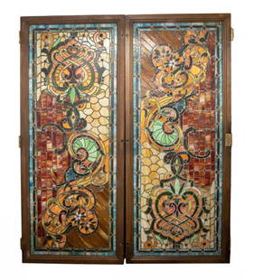 (2) 8 FOOT X 40" STAIN GLASS PANELS, OAK FRAMED: Art Nouveau Style in warm floral colors with some scrollwork and cross hatching, mounte in hinged door, wth black fabric backing. 86" x 40" 2 1/2".