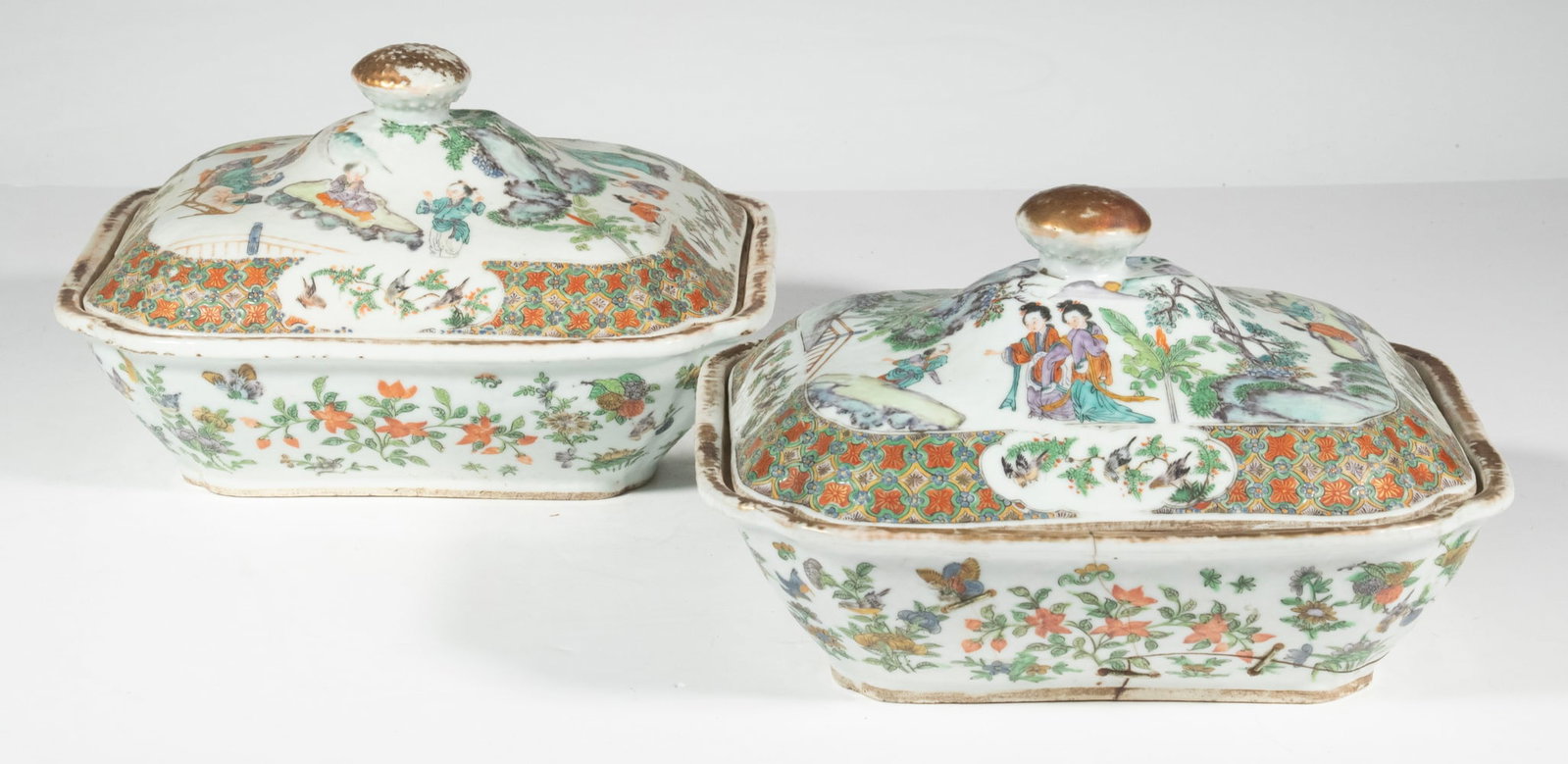 PR CHINESE FAMILLE VERTE COVERED SERVING DISHES, 18TH CENTURY: Pair of 18th c. Lidded Dishes, with hand painted polychrome enamel figural, floral, bird and butterfly decoration, gilded rims and lid finials. Both bases with staple repairs; one lid with corner chip