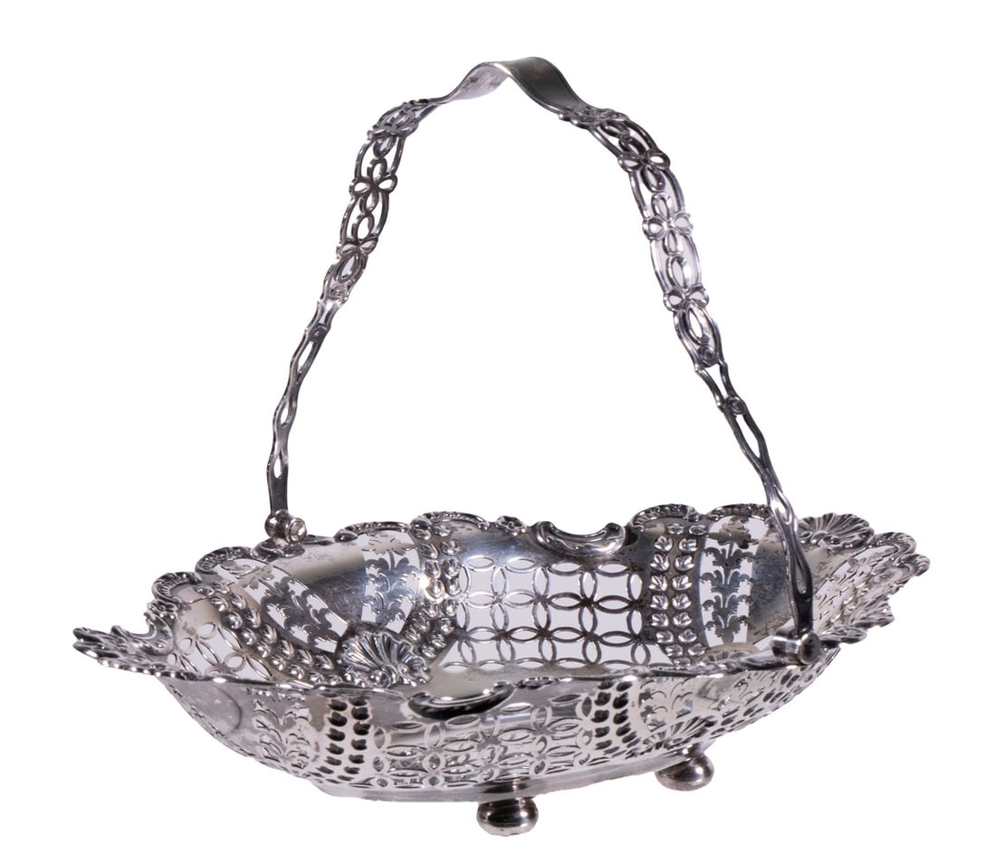 ENGLISH STERLING PIERCED BASKET: Late Victorian Era Silver Oval Basket, by William Hutton & Sons, London, 1899, with reticulated swing handle, intricate pierced sides with raised shell, scroll and leaf decoration, set on ball form fe