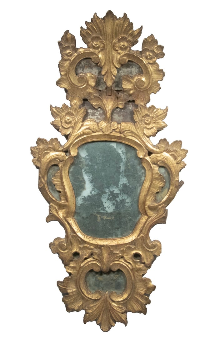 18TH C. ITALIAN GILTWOOD MIRROR: Florentine Rococo Style, retaining the original thin silvered glass, the top canted out slightly, also backed by glass, losses to silvering, great age patina. Converted dimensions: 33 x 16 in. (83.8 x