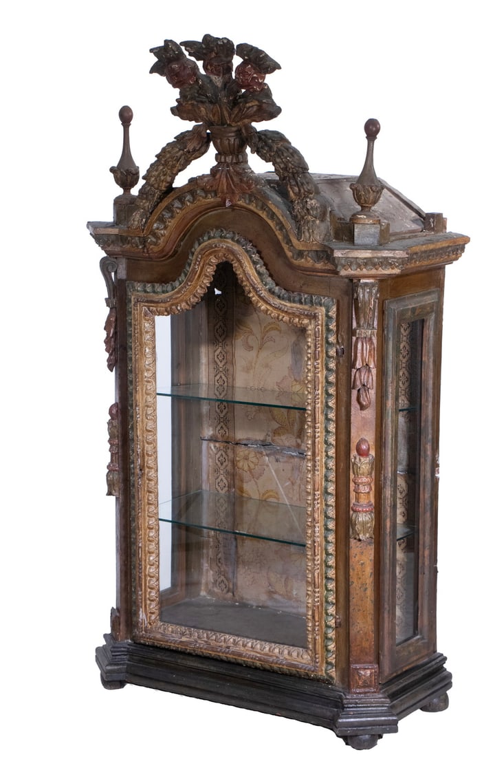 LARGE 18TH C. ITALIAN VITRINE WITH CUSTOM MODERN DISPLAY STAND: Ornate Rococo Style Glass Vitrine in polychrome painted gesso over carved wood, having an arched front surmounted by a floral urn, flanked by large finials above canted stiles, the conforming molded g