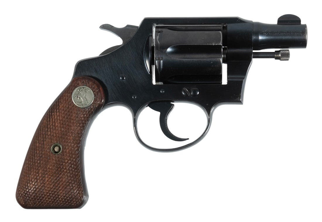 COLT DETECTIVE SPECIAL SNUB NOSE REVOLVER, .38 SPL: An essential piece of kit for any gumshoe. The revolver features a blued finish throughout, checkered grip panels with Colt medallions, and fixed sights. The piece is in overall good condition with so
