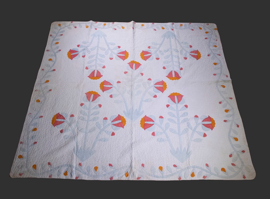 ANTIQUE HAND STITCHED QUILT: Circa 1900 Applique Quilt, tulip and flowering vine design. Edge stains, minor losses. Converted dimensions: 76 x 82 in. (193 x 208.3 cm.)