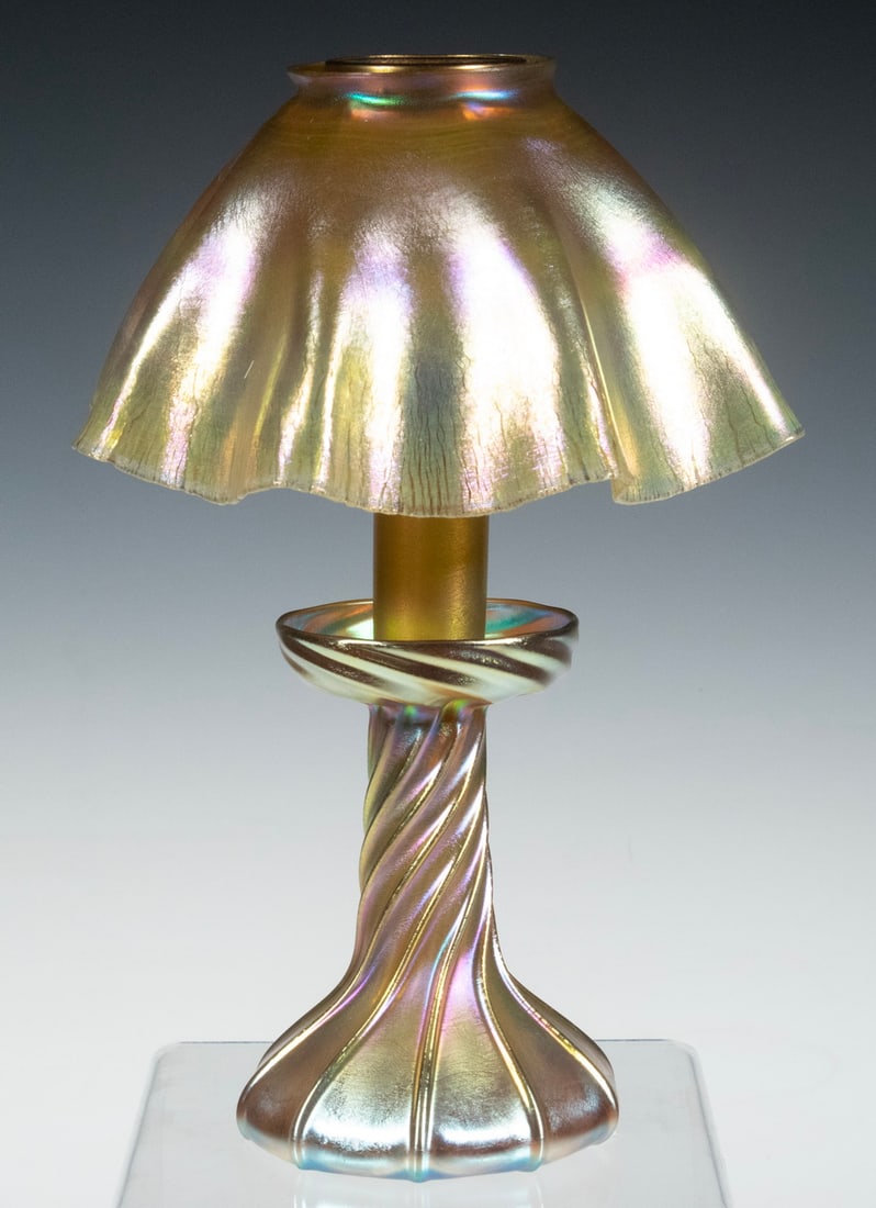 TIFFANY STUDIOS FAVRILE GLASS CANDLE LAMP: Circa 1910 Iridescent Gold Art Glass Lamp, by Louis Comfort Tiffany for Tiffany Studios, with base, insert and ruffled shade, the base is signed "L.C.T." and the shade is signed "L.C.T. Favrile", 11"