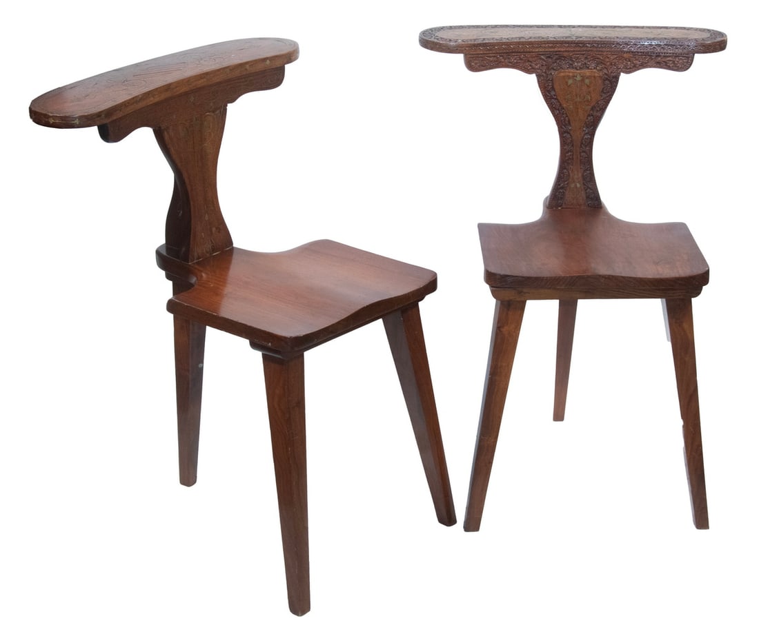 (2) SIMILAR ANGLO-INDIAN COCK FIGHTING CHAIRS: Sandalwood with brass wirework on both and low relief carving on one, both raised on three simple legs, 18" seat, 30" back, 21 1/2" x 22".From the private collection of Sally Jessy Raphael