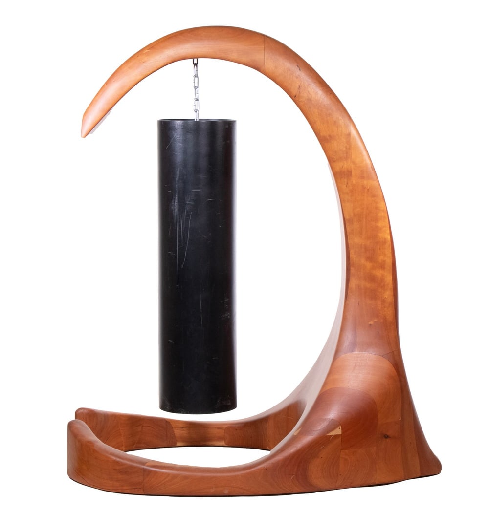 CHERRY MEDITATION GONG STAND, FOLLOWER OF WHARTON ESHERICK (PA, 1887-1970): Post-Modernist Abstract form, in laminated cherry, with iron cylindrical Koshi gong. 31 1/2" tall, 45" x 26" overall, 33" x 9" diam. gong. Converted dimensions: Overall: 31 1/2 x 45 x 26 in. (80 x 114