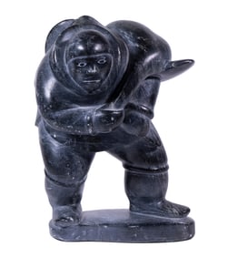 INUIT SCULPTURE OF HUNTER WITH SEAL