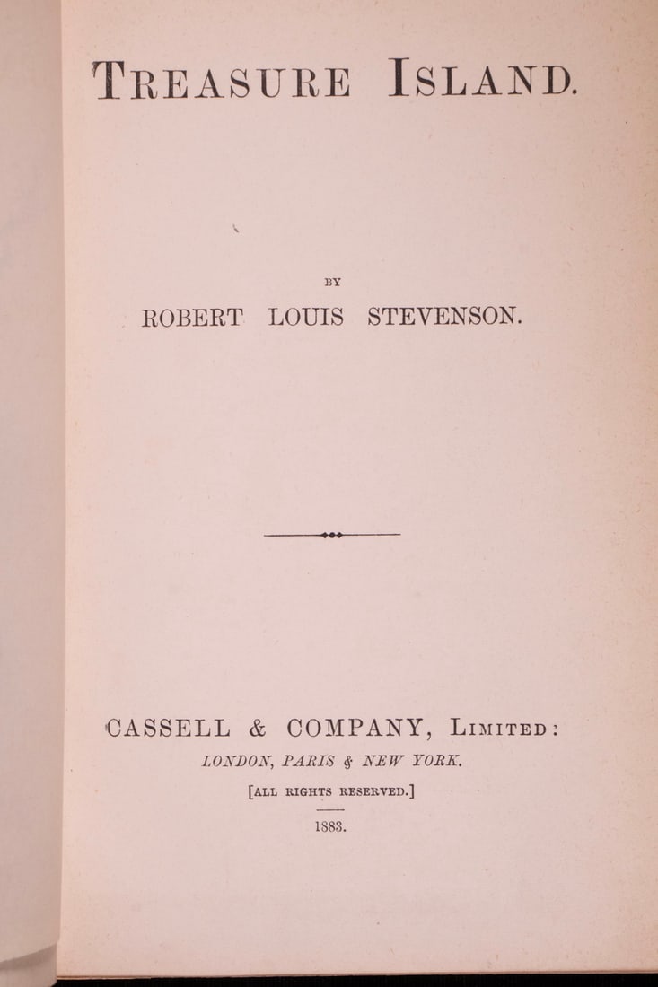 FIRST EDITION FIRST STATE BOOK "TREASURE ISLAND", 1881: Treasure Island by Robert Louis Stevenson, Cassell & Company, Limited. London, Paris & New York. 1883. Frontispiece map in three colors with tissue guard. viii, 292, 8 [ads] pp. 8vo. In full crimson p