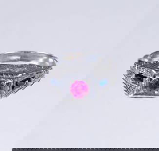ART DECO 18K WHITE GOLD AND RUBY RING: Featuring an engraved setting with round ruby flanked on either side by baguette cut sapphires, Size: 6; 2.7dwt. tw. Good condition. Dimensions Ring Size: 6