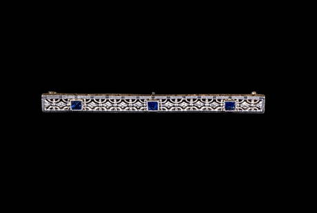EDWARDIAN 14K GOLD AND SAPPHIRE BAR BROOCH: Rectangular bar brooch with openwork filigree design, set with (3) square-cut blue sapphires, yellow gold backing, stamped "14K"; size 2 1/2" x 3/8"; 3.1 dwt. tw. Good condition. Dimensions 2 1/2 x 0.
