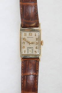 VINTAGE 14K GOLD GENT'S WRISTWATCH, HAMILTON: Vintage Hamilton Curved Tank Form Wristwatch with 14K yellow gold square head, gold stamp to case back. Recently serviced, with new embossed brown leather band. Dimensions