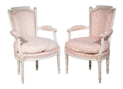 PAIR OF LOUIS XVI STYLE UPHOLSTERED ARMCHAIRS: Pair of Hand Carved Armchairs in cream paint and pink cotton upholstery, raised on round fluted legs, the loose down seat cushion self-corded, roping as other trim. 16" seat, 24" arms.From the estate