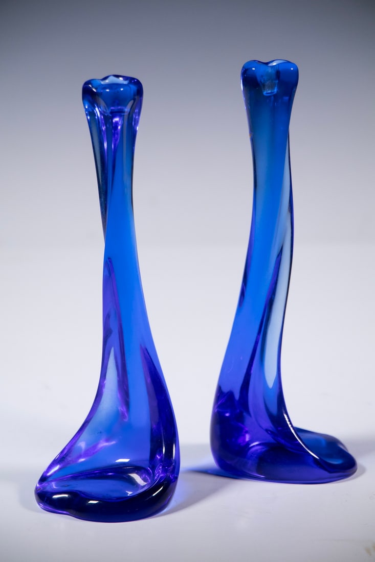 PR ELSA PERETTI FOR TIFFANY BLUE GLASS CANDLESTICKS: Pair of Cobalt Blue Glass "Bone" Candle Holders, designed by Elsa Peretti for Tiffany & Co., made in Belgium, signed on base. One with top corner flake.From the estate of Brooke Astor at her summer re