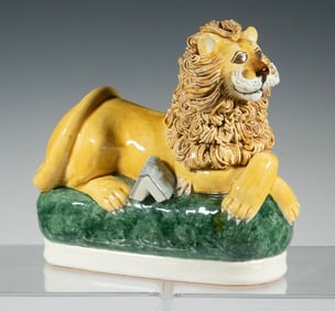 ENGLISH STAFFORDSHIRE POTTERY FIGURE OF A RECLINING LION