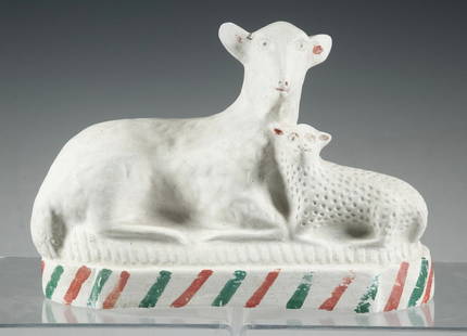 AMERICAN PAINTED CHALKWARE LAMB AND EWE, PENNSYLVANIA: Folk art style chalkware figure of a reclining lamb and ewe on a striped base, likely Pennsylvania origin. Lightweight composition, flat-back form for mantel display. Traces of original paint remain.