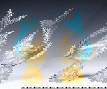 PR ITALY MURANO VENETIANART GLASS FISH SCULPTURES WITH GOLD FOIL: A vibrant pair of hand-blown Murano art glass fish sculptures, each with upward-curved turquoise tails and embedded gold leaf throughout the body and base. Displaying expressive fins, bulging eyes, an