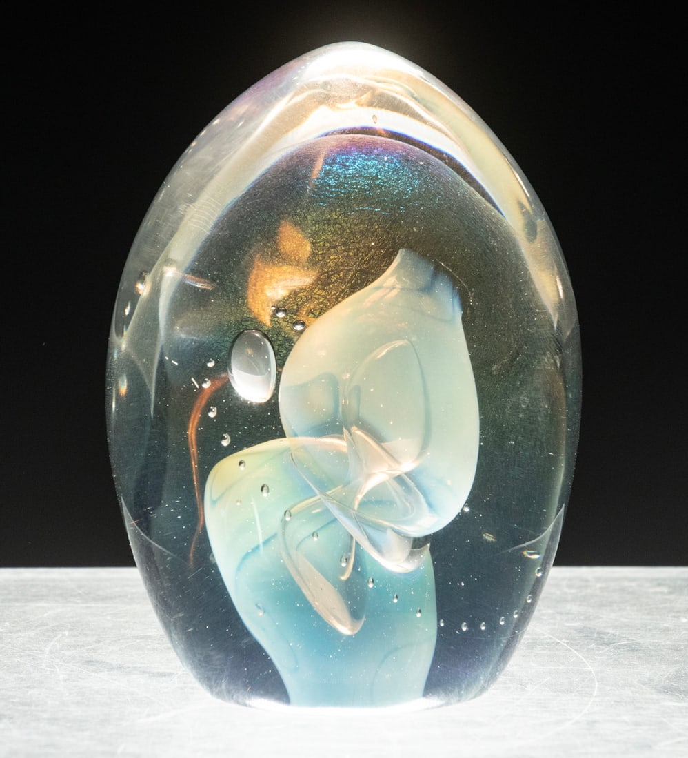 ROBERT EICKHOLT (OH/CA, 1947-): Art Glass Paperweight, with interior controlled bubbles and swirling opalescent forms, inscribed "Eickholt" and dated 1985 on base.From the estate of Marilyn Coburn. 5 1/2 x 3 3/4 x 3 in. (14 x 9.5 x