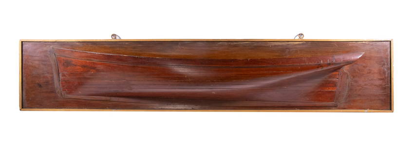 LATE 19TH C. FOUR FOOT LAMINATED HALF HULL: Circa 1875 Laminated Spruce Sailing Ship Half-Hull with broad bottom, shallow keel, vertical prow, mounted on a mahogany plank, with gold painted slat frame. 10 1/2 x 53 1/2 x 7 1/2 in. (26.7 x 135.9