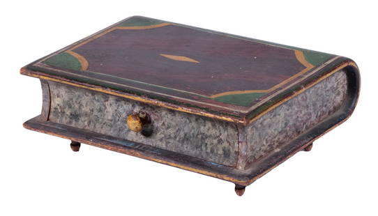 FOLK ART PAINTED BOOK FORM BOX: 19th c. Paint Decorated Wooden Box, in the form of a book, having a pull-out drawer with interior LHR penciled monogram, set on four turned feet, with green and gold painted "binding" on a grain paint