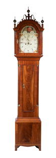 TALL CLOCK BY JAMES CARY OF BRUNSWICK, MAINE: Signed Flame Mahogany Case Chippendale, with filigree bonnet having brass finials and full round columns with brass fittings, four day time and strike brass works, painted steel dial with peach bracke