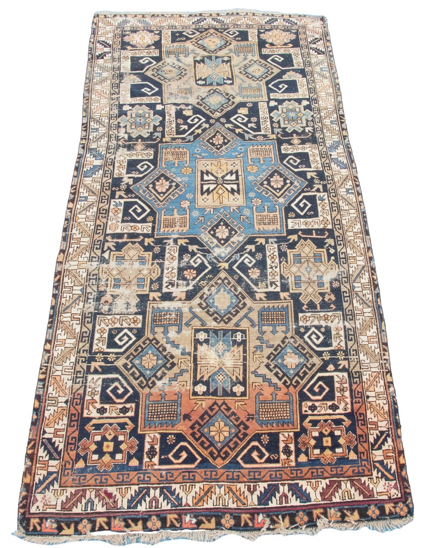 DAHESTAN LONG RUG (5' X 11'3"): Northeast Caucasus, early 20th C., column of three large gabled square medallions in brick, midnight & sky blue, ivory. Midnight blue field with ivory serrated leaf & wine cup border. Areas of wear, r