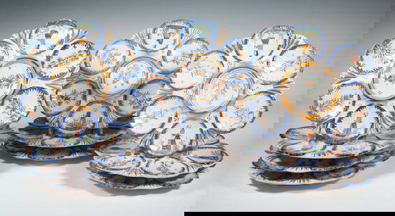 (10) HENRIOT QUIMPER FAIENCE FLORAL OYSTER PLATES, FRANCE: Hand-painted tin-glazed earthenware, each scalloped plate featuring six shallow wells and a central dip section, decorated with stylized floral sprays and alternating figures of Breton men and women i
